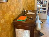 an image of a room with a desk and a chair