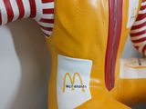a statue of a clown wearing a pair of boots