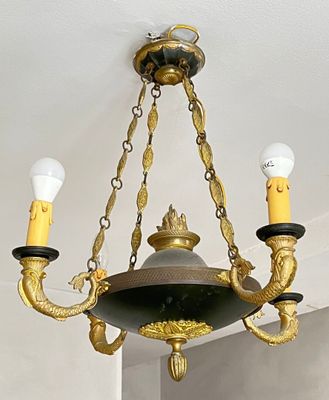 a gold chandelier with three lights hanging from the ceiling