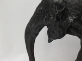 a statue of an elephant that is standing on a table