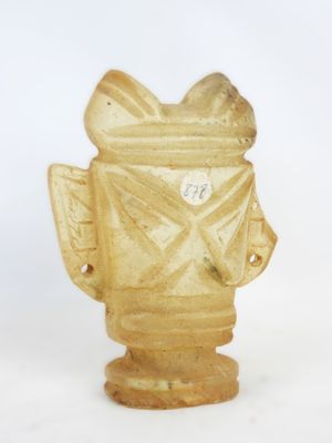 a small statue of a fire hydrant on a white surface