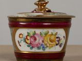 a close up of a bowl with a lid on a table