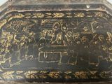a black and gold box with a painting on it