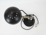 a black lamp that is on a white table
