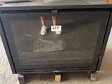 a person standing in front of a stove in a room