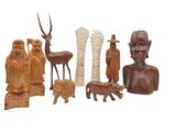 a lot of wooden sculptures that are on a white surface