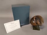 a small figurine of a bird on a table next to a box