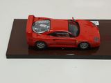 a red model of a car on display on a table