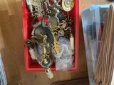 a red box filled with assorted items on a wooden floor