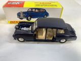 an old model of a black car in front of a boxed box