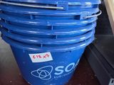 a large blue bucket sitting on the floor next to a shelf