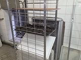 a metal cart with a bunch of boxes on top of it