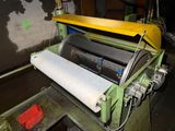a machine that has a roll of paper on it