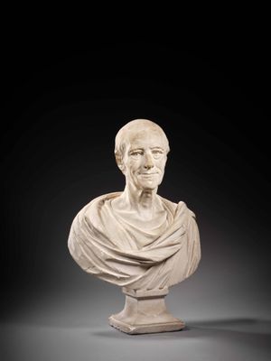 a white marble bust of a man wearing a cloak