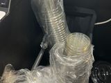 a pile of plastic cups and a laptop in a trash can