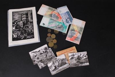 a picture of a bunch of money and a picture of a building on a table
