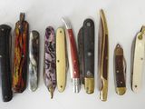 several different types of knives are lined up on a white surface