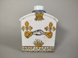 an image of a white and blue vase with a bird on it