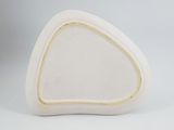 a close up of a white vase with a triangular shape