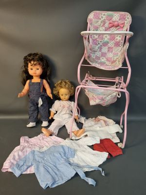 two dolls that are next to each other on a table