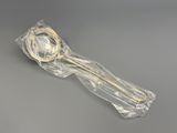 a plastic spoon with a wooden handle on a gray surface