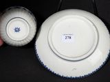 a white plate with blue trim and a white plate with a blue trim
