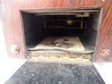 an old fashioned oven with a book inside of it