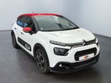 the white and red citrole is parked in a room