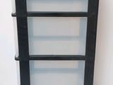 a black and white shelf with four drawers on it
