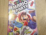 a nintendo wii game super mario party on a wooden table