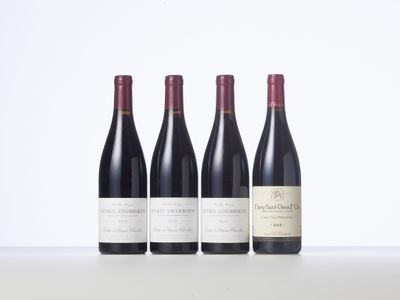 three bottles of wine are lined up on a table