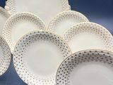 six white and black polka dot dinner plates with gold rims