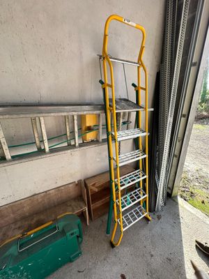 a ladder that is leaning against a wall in a garage