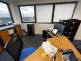 a desk with a phone and a telephone on it in an office