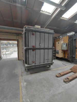 a large metal container in the middle of a warehouse