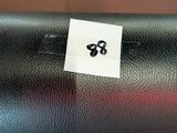 a close up of a black leather chair with a sticker on it