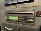 a close up of a car radio with a clock on it