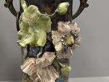 two vases sitting on a table with flowers in them