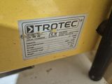 a close up of a yellow machine with a sticker on it ' s side