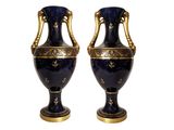two blue vases with gold decoration on them