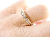 a woman ' s hand with a diamond ring on it