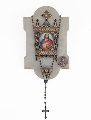 an image of a rosary hanging on a wall with a picture of jesus