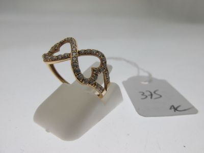 an image of a gold ring with brown diamonds on a white surface