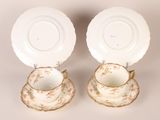pair of antique porcelain plates and saucers with floral designs
