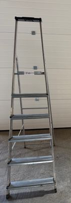 a ladder leaning against a wall in a garage
