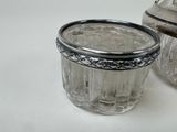 a glass jar with a silver lid next to a glass jar with a silver lid