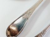 two spoons and a bowl of fruit on the table