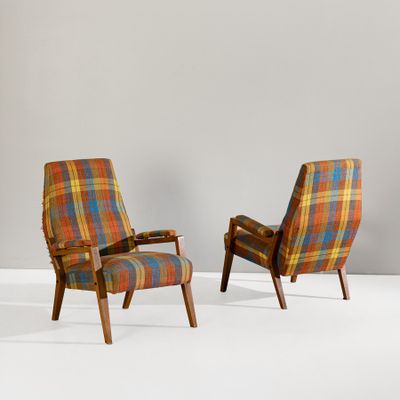 pair of mid century lounge chairs in the style of person