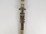 an old metal knife with a wooden handle on a white surface