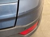 a close up of a car ' s rear bumper with a hole in it